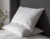 2 pillows stacked on bed